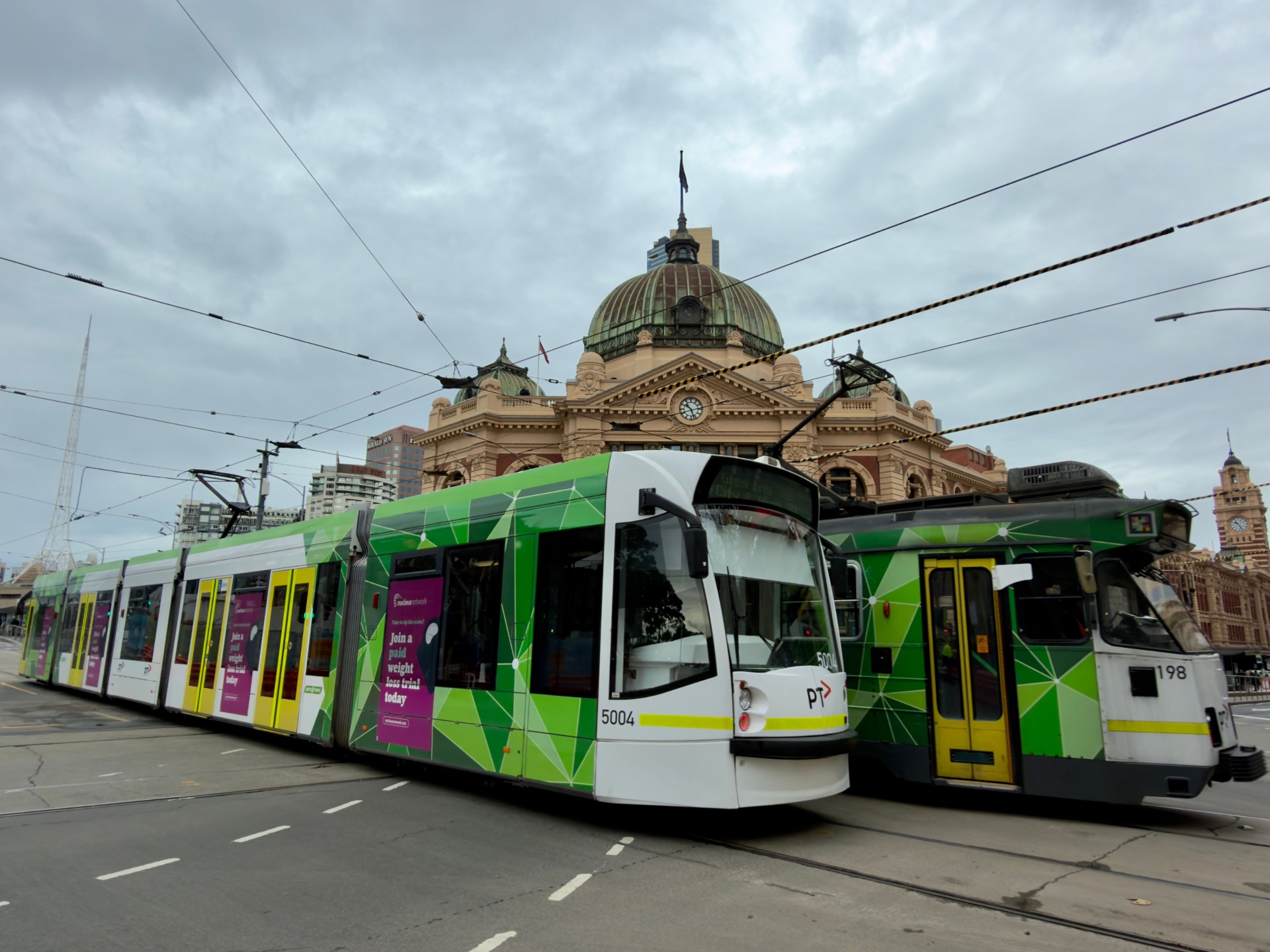 Melbourne trams passing Flinders Street Station in the CBD